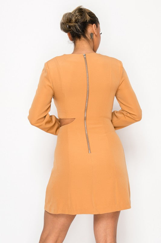 Woman wearing a long-sleeve mini dress with asymmetrical cutouts across the chest and midriff, styled against a plain white background.