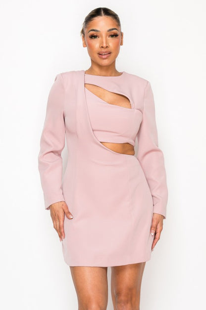 Woman wearing a long-sleeve mini dress with asymmetrical cutouts across the chest and midriff, styled against a plain white background.