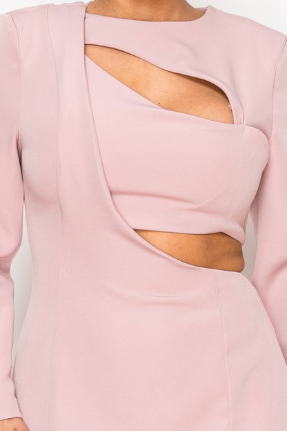 Woman wearing a long-sleeve mini dress with asymmetrical cutouts across the chest and midriff, styled against a plain white background.