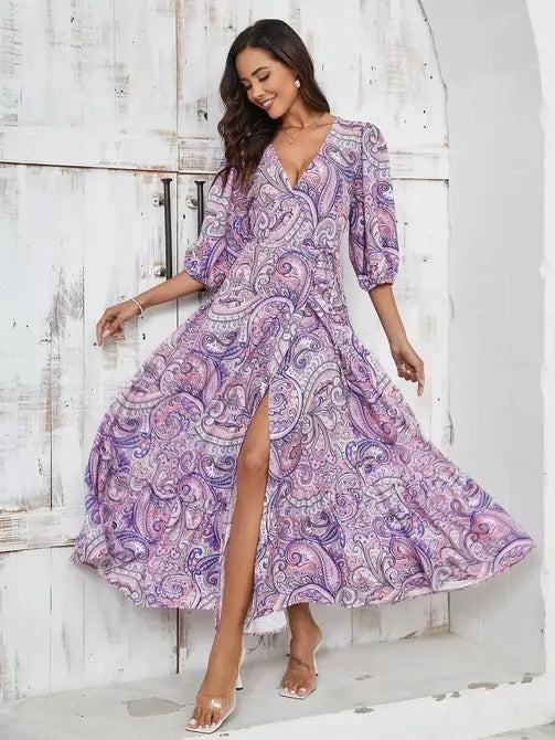The woman in the pic is rocking a gorgeous purple paisley dress with a V-neck and slits that give it a super chic vibe. 