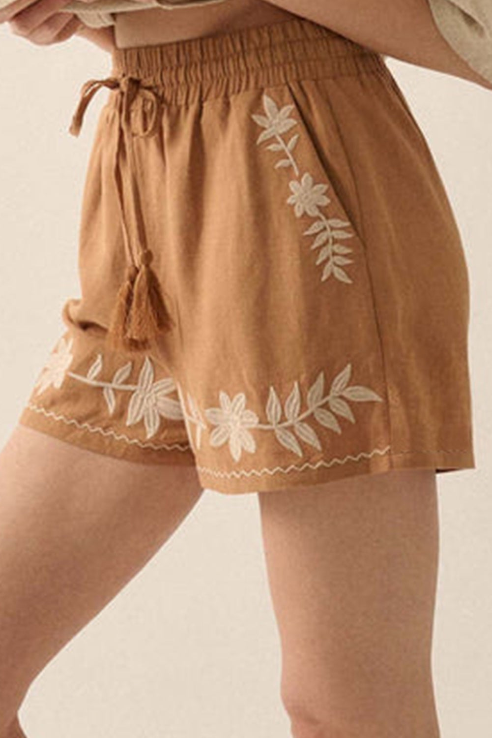 Khaki boho casual shorts with floral embroidery, tasseled drawstring, and elastic waistband for a comfy, chic summer look.