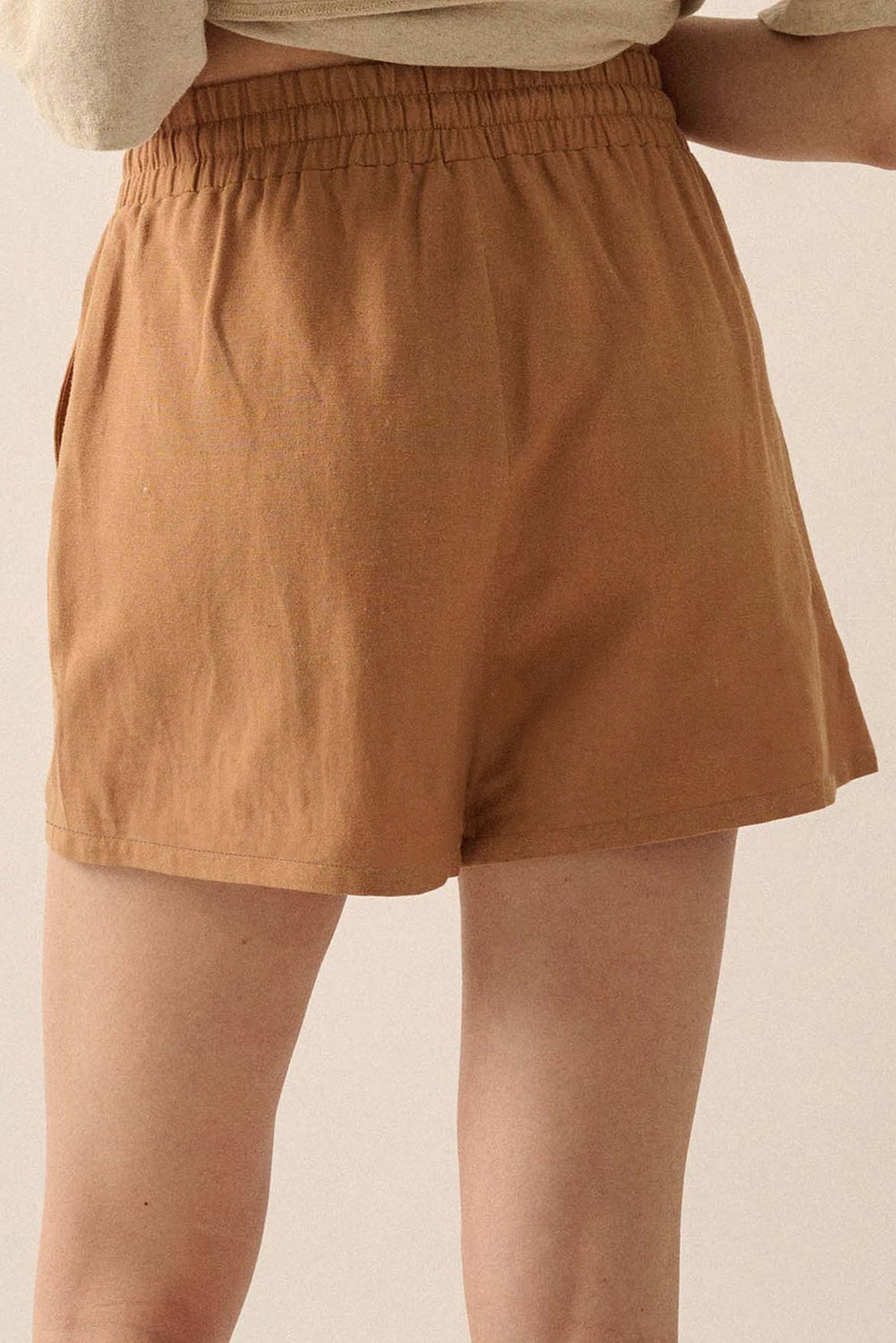 Khaki boho casual shorts with floral embroidery, tasseled drawstring, and elastic waistband for a comfy, chic summer look.