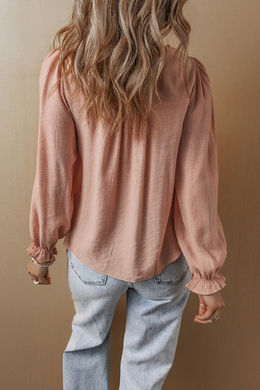 Flounce sleeves deliver a feminine silhouette with a graceful flutter. 