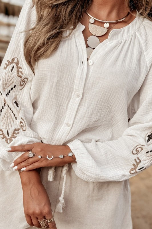 Puff sleeves bring a soft, feminine touch.