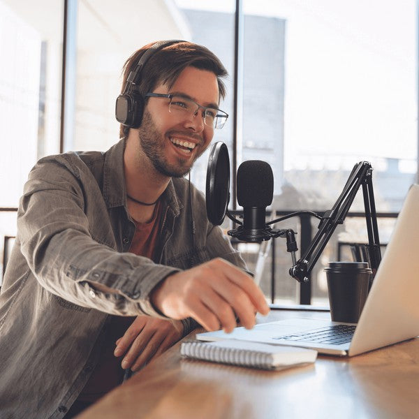 A condenser microphone setup with pop filter, foam windscreen, and boom arm, featuring echo, volume, and mute controls—ideal for recording and streaming.