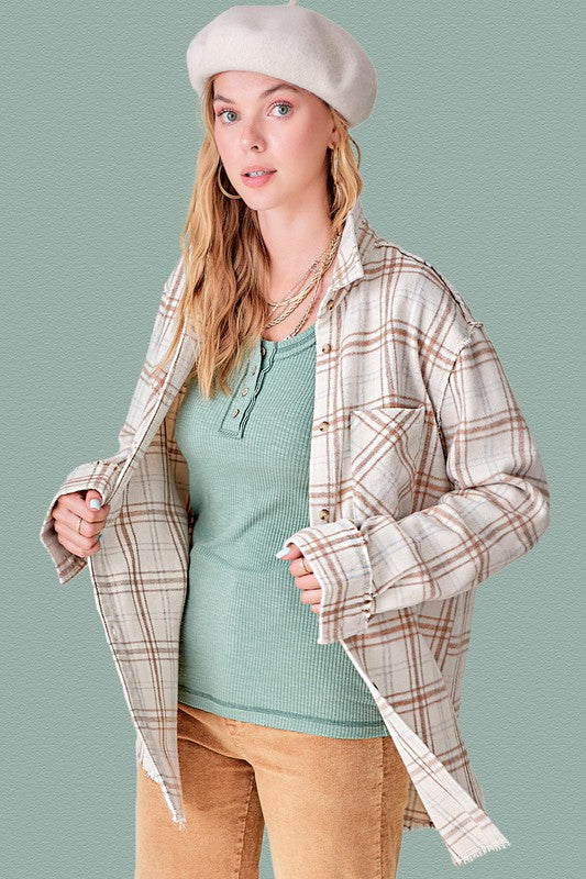 The button-down front adds structure and allows for various styling options. 