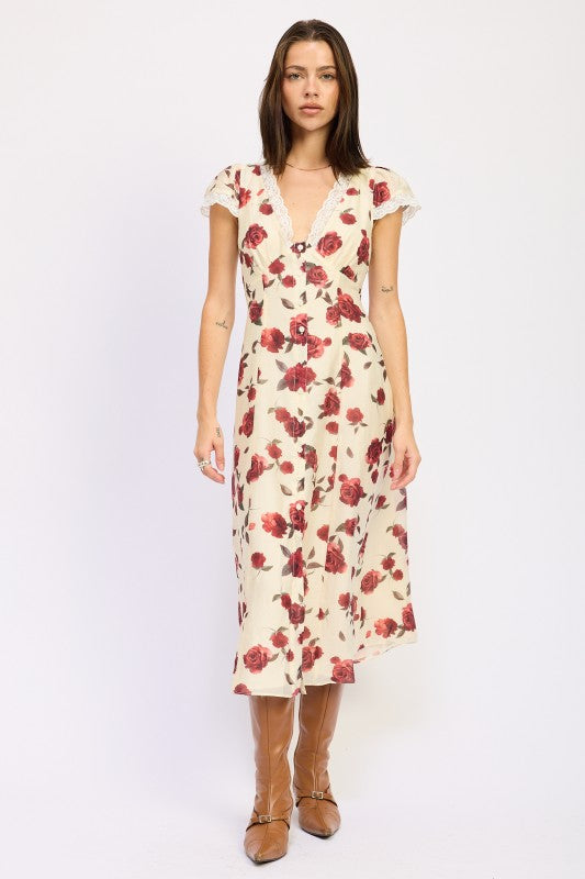 Woman models a vintage-inspired cream midi dress with red rose print, front view.