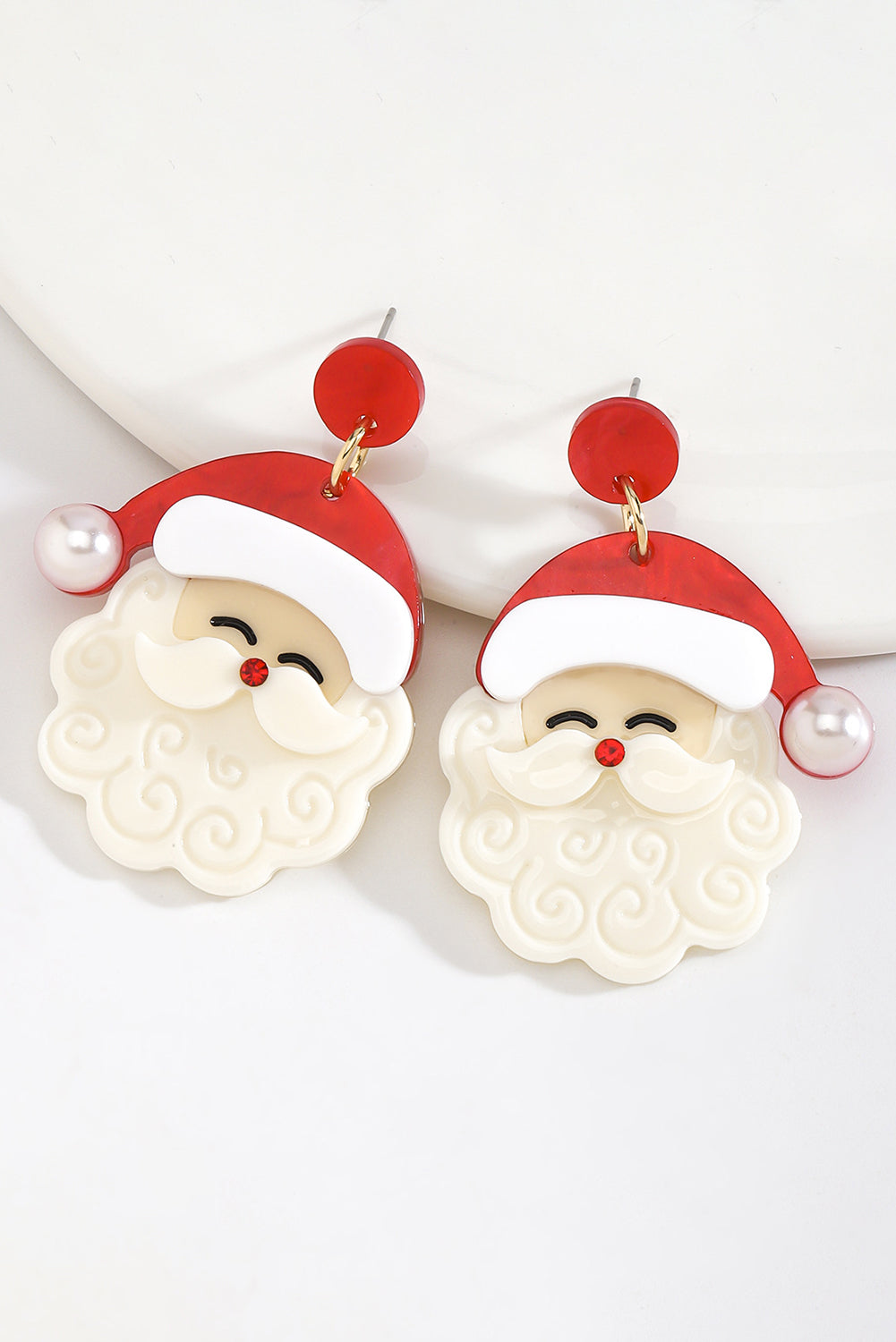 ingle all the way—in style. These adorable Father Christmas earrings are the perfect way to add a little holiday cheer to your look. Featuring a fiery red base, bright pearl accents, and a charming Santa design, they’re festive, fun, and totally irresistible.