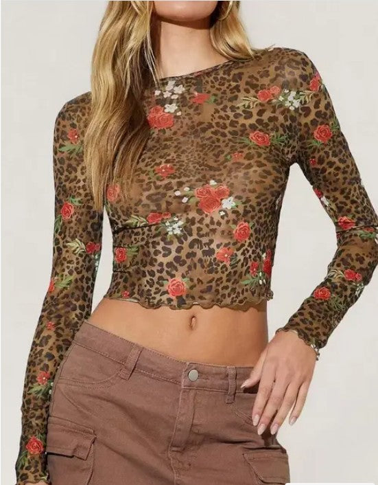 Sheer mesh cropped top blending playful floral and bold leopard prints, with a fluttery ruffle hem for flirty style. 