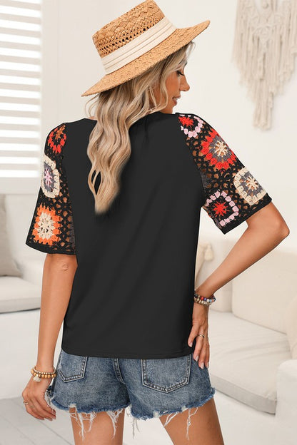 Feminine detailing without fuss — crochet sleeves elevate this tee.