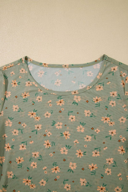 A sheer green floral top hanging beautifully.  