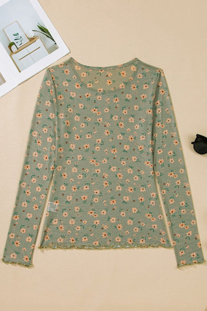 A sheer green floral top hanging beautifully.  