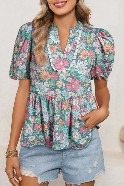 Floral print design gives this blouse a soft, romantic appeal.