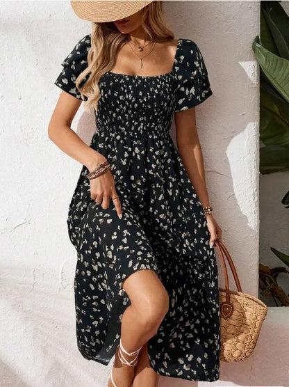 A woman wearing a black Floral Ruffle Midi Dress, front facing view.