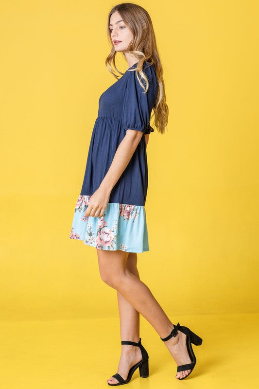Woman wearing a Floral Two Tone Tiered Mini Dress
