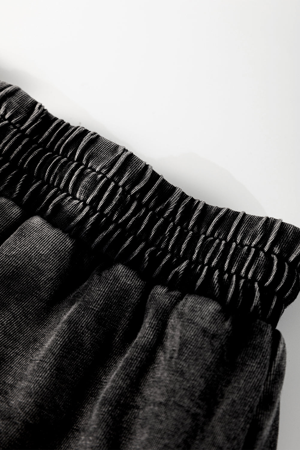A mineral wash French terry shorts with an elastic waistband and drawstring, paired . The shorts look soft, comfortable, and ideal for casual wear, lounging, or street style