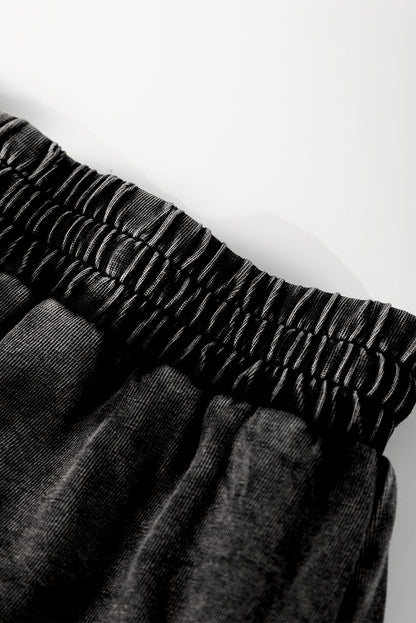 A mineral wash French terry shorts with an elastic waistband and drawstring, paired . The shorts look soft, comfortable, and ideal for casual wear, lounging, or street style