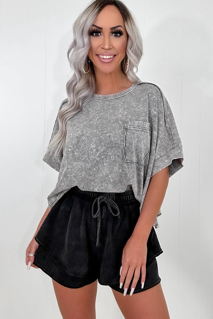 A person wearing black mineral wash French terry shorts with an elastic waistband and drawstring, paired with a white crop top. The shorts look soft, comfortable, and ideal for casual wear, lounging, or street style