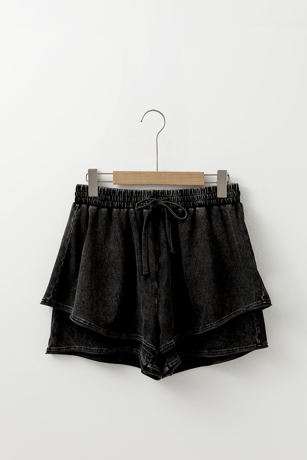 A mineral wash French terry shorts with an elastic waistband and drawstring, paired . The shorts look soft, comfortable, and ideal for casual wear, lounging, or street style