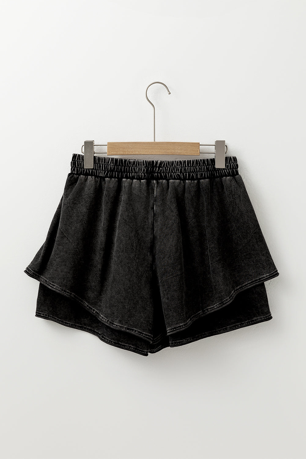 A mineral wash French terry shorts with an elastic waistband and drawstring, paired . The shorts look soft, comfortable, and ideal for casual wear, lounging, or street style