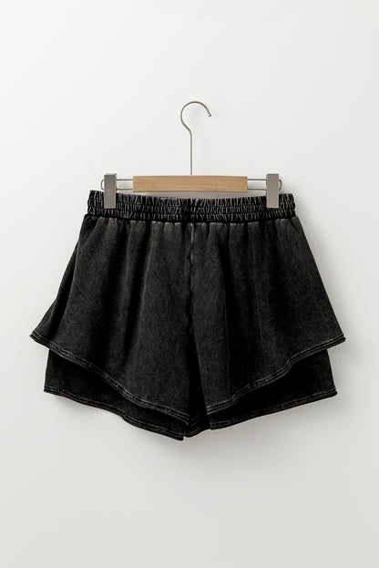 A mineral wash French terry shorts with an elastic waistband and drawstring, paired . The shorts look soft, comfortable, and ideal for casual wear, lounging, or street style