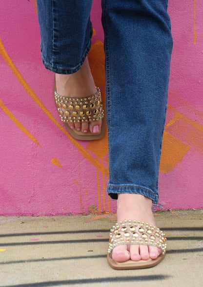 Slip-on sandals with pearl and stud embellished upper band, square toe silhouette, flat sole, and open-toe design
