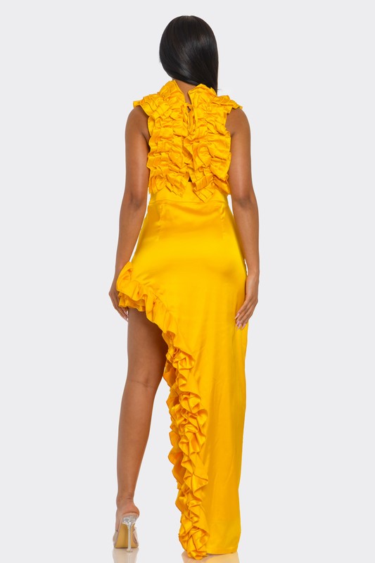 A bright yellow, one-shoulder dress with ruffle detailing along the neckline and a high side slit.