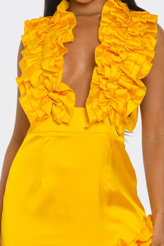 A bright yellow, one-shoulder dress with ruffle detailing along the neckline and a high side slit