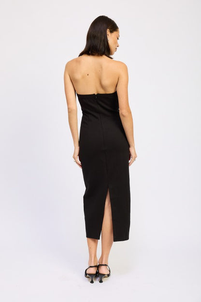 Woman models a chic halter neck midi dress in a black color, featuring an elegant design, back view.
