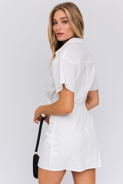 Half-sleeve shirt mini dress with collared neckline and button front, relaxed yet structured style ideal for daywear or casual outings