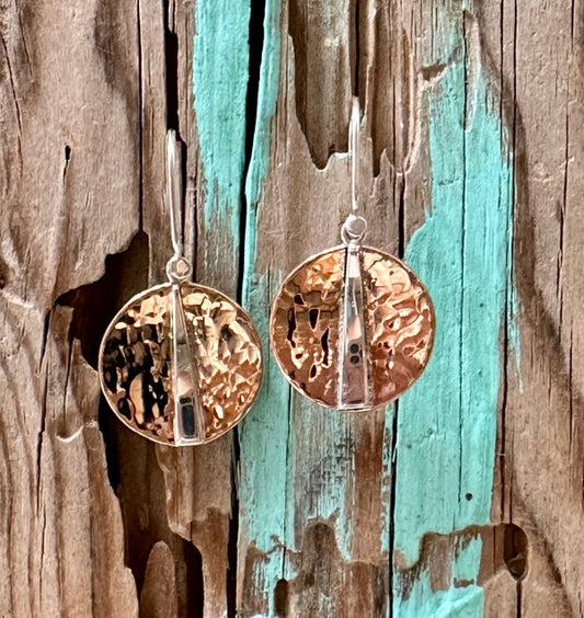 Raw texture. Refined shine. These handcrafted earrings blend the warmth of hammered copper with the cool elegance of sterling silver. Designed for lovers of artisan detail and bold simplicity, they’re perfect for everyday wear or special occasions.