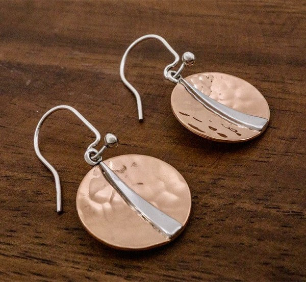 Raw texture. Refined shine. These handcrafted earrings blend the warmth of hammered copper with the cool elegance of sterling silver. Designed for lovers of artisan detail and bold simplicity, they’re perfect for everyday wear or special occasions.