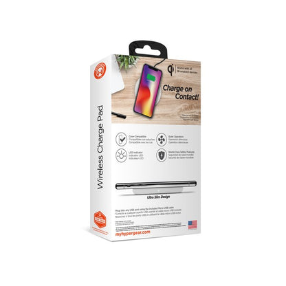A HYPERGEAR Qi wireless charging pad powering a smartphone to 100%, with a connected cable and glowing charge indicator.