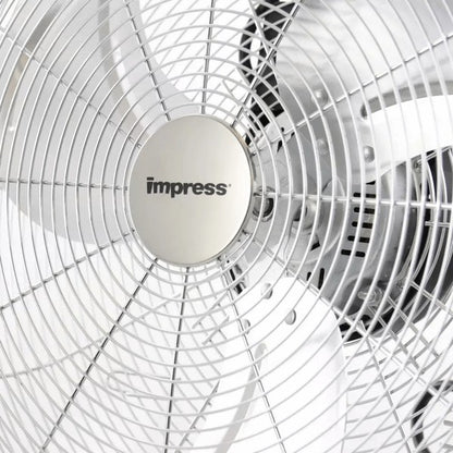 Metallic Impress floor fan with five blades and circular grille—mounted on a sturdy angled stand with rubber feet, designed for high-velocity cooling.