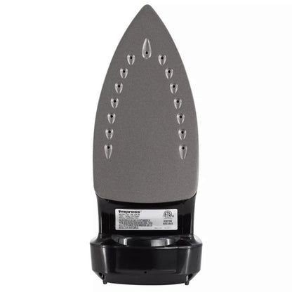 Black Impress steam iron standing upright with a temperature dial, steam control knob, and red indicator light—next to a small transparent measuring cup.
