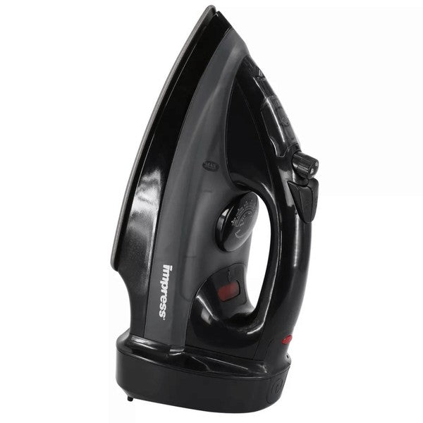 Black Impress steam iron standing upright with a temperature dial, steam control knob, and red indicator light—next to a small transparent measuring cup.