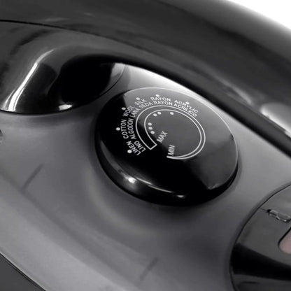 Close-up of a steam iron’s temperature dial labeled with fabric types—currently set to “MAX,” suitable for ironing heavy materials like cotton and linen.
