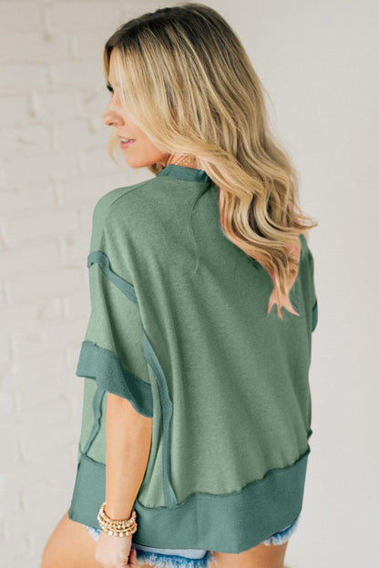 Inside-out stitch detailing gives it a raw, textured edge.