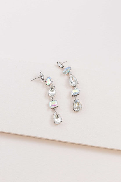Light-catching elegance in every drop. These Iridescent Flare Dangle Earrings are designed to shimmer with every movement, featuring crystal-clear accents and a radiant finish that transitions effortlessly from day to night.