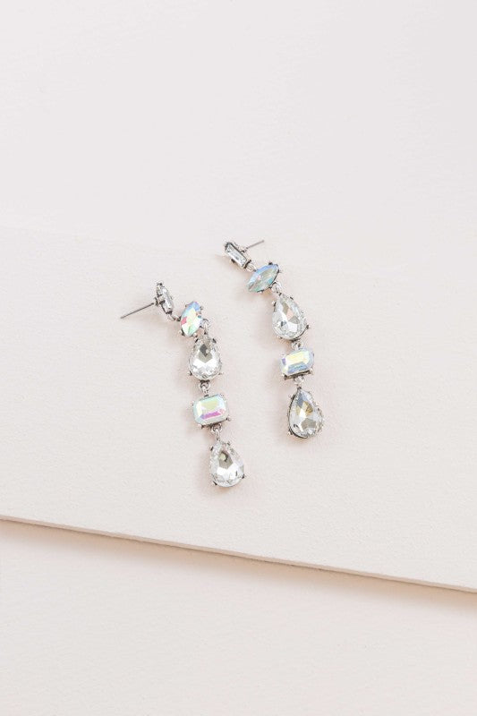 Light-catching elegance in every drop. These Iridescent Flare Dangle Earrings are designed to shimmer with every movement, featuring crystal-clear accents and a radiant finish that transitions effortlessly from day to night.