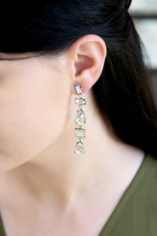 Light-catching elegance in every drop. These Iridescent Flare Dangle Earrings are designed to shimmer with every movement, featuring crystal-clear accents and a radiant finish that transitions effortlessly from day to night.