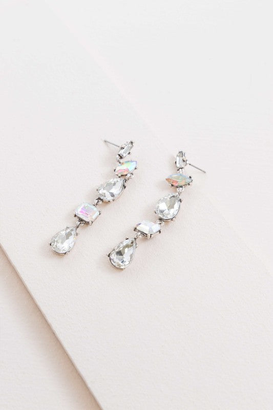 Light-catching elegance in every drop. These Iridescent Flare Dangle Earrings are designed to shimmer with every movement, featuring crystal-clear accents and a radiant finish that transitions effortlessly from day to night.