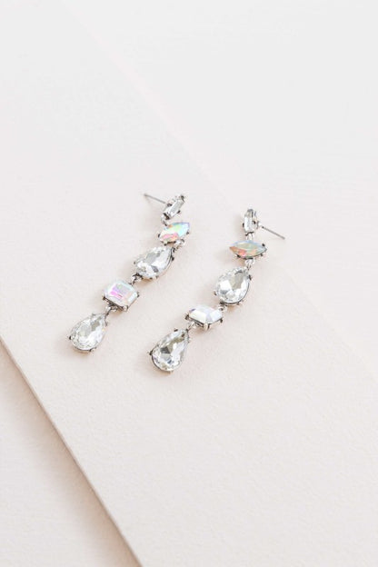 Light-catching elegance in every drop. These Iridescent Flare Dangle Earrings are designed to shimmer with every movement, featuring crystal-clear accents and a radiant finish that transitions effortlessly from day to night.