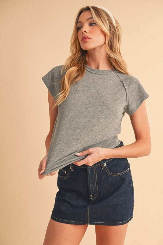 Cropped boxy cut pairs well with high-waisted bottoms.