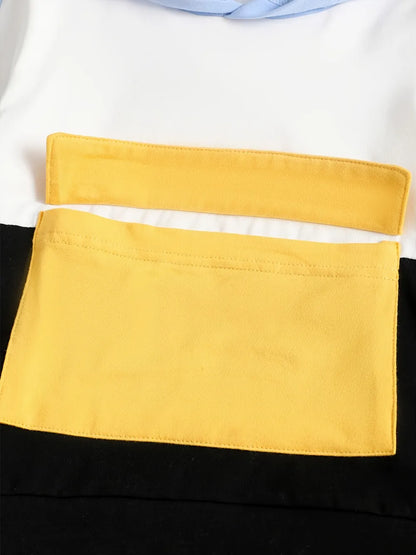 Close-up of a yellow pocket on a black and white garment