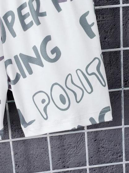 White towel with gray text on a black tiled floor