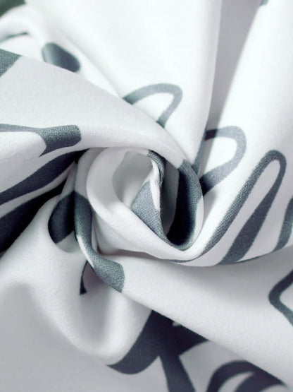 Close-up of fabric with black and gray abstract pattern on white background