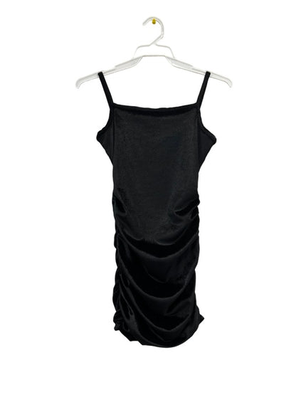 Black dress on a hanger against a white background