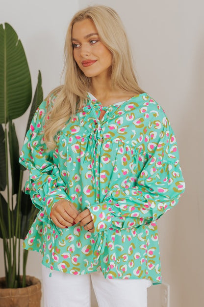 Voluminous lantern sleeves add drama and elegance. 