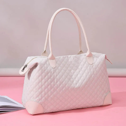 Light pink quilted handbag with diamond stitching, sturdy handles, and a zippered top. Elegant and structured—perfect for everyday or casual outings.